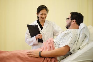 nursing student checking on a patient